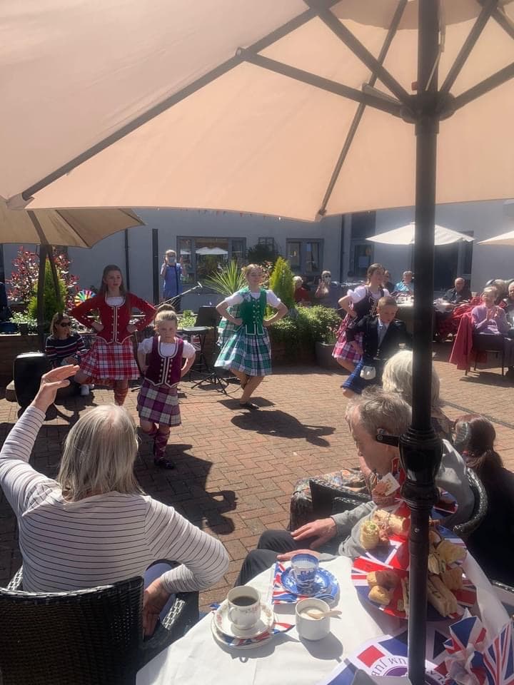 Residents Watching Dance Performance at Jubilee Party